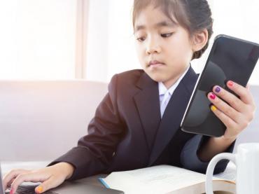 Young Asian Girl In Business Suit Holding Calculator And Working On Laptop